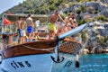 Turkish tourists relaxing on deck excursion yacht, sunny summer