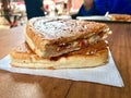 Turkish Utu Tost / Toast Sandwich on Wooden Table Surface. Street Food