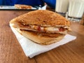 Turkish Utu Tost / Toast Sandwich on Wooden Table Surface. Street Food