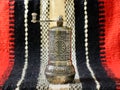 Turkish vintage hand spice grinder on an old handcrafted woven fabric. Royalty Free Stock Photo