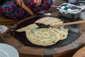 Turkish woman prepares Gozleme - traditional dish in the form of flatbread stuffed with greens and cheese