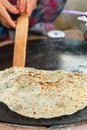 Turkish woman prepares Gozleme - traditional dish in the form of flatbread stuffed with greens and cheese