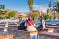 Turkish women wearing traditional clothes and sitting on the chairs located between Blue Mosque and Hagia Sophia mosque under