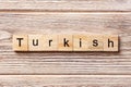 Turkish word written on wood block. Turkish text on table, concept