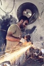 Turkish worker using an angle grinder