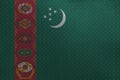Turkmenistan flag depicted in paint colors on old brushed metal plate or wall closeup. Textured banner on rough background Royalty Free Stock Photo