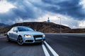 Sporty German Audi sedan on a winding mountain road.