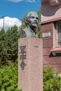 Vladimir Lenin bust next to visited house by Vladimir Ilyich Ulyanov in 1907 during his escape from Tsarist Russia