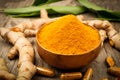 Turmeric capsule and turemeric powder in wood bowl on old wood table background. Herbal Royalty Free Stock Photo