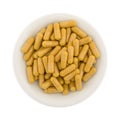 Turmeric capsules in a white bowl Royalty Free Stock Photo
