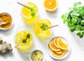 Turmeric, ginger, orange lemonade. Summer cold drink on light background, top view Royalty Free Stock Photo