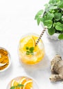 Turmeric, ginger, orange lemonade. Summer cold drink on light background, top view Royalty Free Stock Photo
