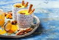 Turmeric golden milk latte with cinnamon sticks and honey. Detox, immune boosting, anti inflammatory healthy cozy drink. Royalty Free Stock Photo