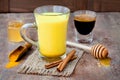 Turmeric golden milk latte with cinnamon sticks and honey. Detox liver fat burner, immune boosting, anti inflammatory drink Royalty Free Stock Photo