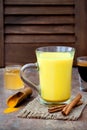 Turmeric golden milk latte with cinnamon sticks and honey. Detox liver fat burner, immune boosting, anti inflammatory drink Royalty Free Stock Photo