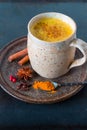 Turmeric golden milk latte with cinnamon sticks