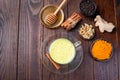 Turmeric moon milk in glass cup, ingredients on background, horizontal, top view, copy space Royalty Free Stock Photo