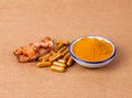 Turmeric powder and capsule and roots curcumin on brown paper