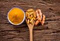 turmeric powder , capsule and roots curcumin on wooden plate Royalty Free Stock Photo