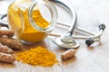 Turmeric powder and turmeric roots with stethoscope, natural medicine