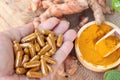 Turmeric powder with tumeric capsules for health. Royalty Free Stock Photo