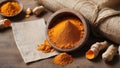 Turmeric powder in a wooden bowl on a wooden table