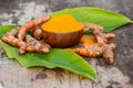 Turmeric powder in wooden bowls on wooden table Royalty Free Stock Photo