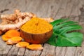 Turmeric powder in wooden bowls on wooden table Royalty Free Stock Photo