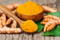 Turmeric powder in wooden bowls on wooden table Royalty Free Stock Photo