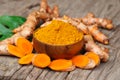 Turmeric powder in wooden bowls on wooden table Royalty Free Stock Photo