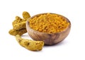 Turmeric rhizome and powder in wooden bowl on white background