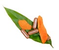 Turmeric Root Powder, Curcuma Root, Turmeric Capsule on Leaf; white background.Herb high vitamin C