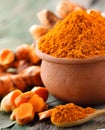 Turmeric roots in the basket on wooden table