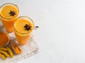 Turmeric smoothie in glass with ingredients, turmeric powder, ginger and spice on white Royalty Free Stock Photo