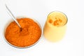 Turmeric Smoothie and Powder in bowl with spoon Isolated on White