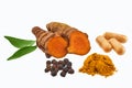 Turmeric and Spices Display. A display of turmeric root, powder, capsules, peppercorns, and leaves Royalty Free Stock Photo