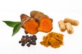 Turmeric and Spices Display. A display of turmeric root, powder, capsules, peppercorns, and leaves Royalty Free Stock Photo