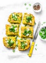 Turmeric, zucchini, mashed chickpeas tortilla with herbs on a light background, top view. Delicious appetizers
