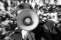 Turmoil on the street. Man is using loudspeaker. Royalty Free Stock Photo
