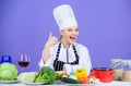 Turn ingredients into delicious meal. Culinary skills. Woman chef wear hat apron near table ingredients. Girl adorable Royalty Free Stock Photo