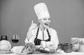 Turn ingredients into delicious meal. Culinary skills. Woman chef wear hat apron near table ingredients. Girl adorable Royalty Free Stock Photo