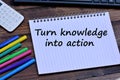 Turn knowledge into action words on notebook Royalty Free Stock Photo