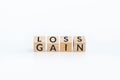 turn loss into gain concept, wooden cube with word LOSS flip to GAIN. capital investment gain and loss, financial while managing Royalty Free Stock Photo