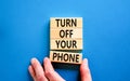 Turn off your phone symbol. Concept words Turn off your phone on wooden blocks. Beautiful blue table blue background. Businessman Royalty Free Stock Photo
