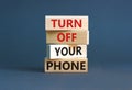 Turn off your phone symbol. Concept words Turn off your phone on wooden blocks. Beautiful grey table grey background. Business, Royalty Free Stock Photo