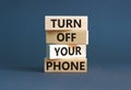 Turn off your phone symbol. Concept words Turn off your phone on wooden blocks. Beautiful grey table grey background. Business, Royalty Free Stock Photo