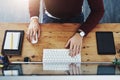 Turn on the productivity. High angle shot of a man using a computer at his desk in a modern office. Royalty Free Stock Photo