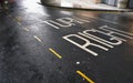 TURN RIGHT sign / text and yellow line on wet asphalt road Royalty Free Stock Photo