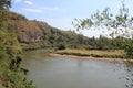 Turn of the river against the backdrop of a mountainous green area Royalty Free Stock Photo