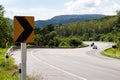 Turn sign on the curve of the mountain.